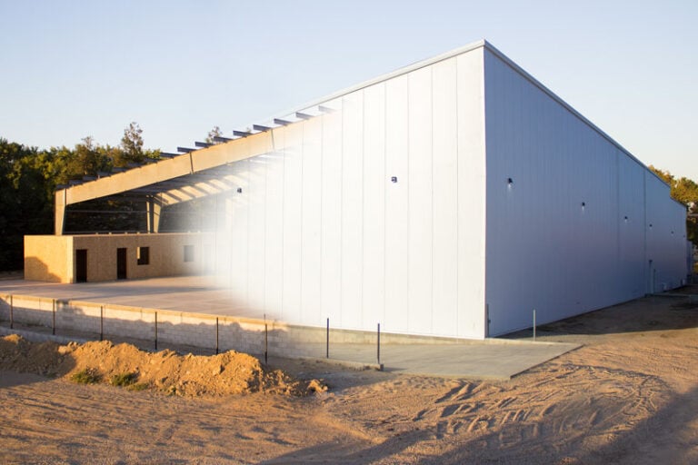 New Quady Winery warehouse with effect showing half of it complete, and half still under construction.