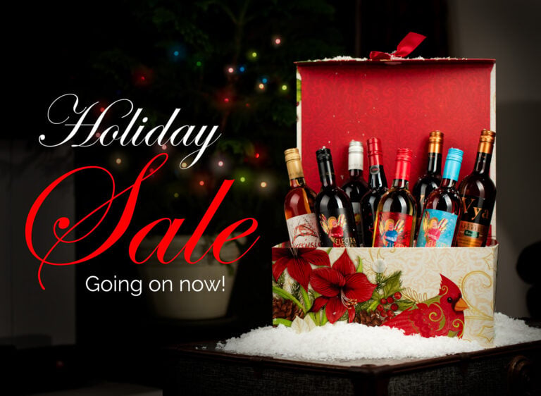 "Holiday Sale, Going on now," text overlaid on a picture of a Christmas tree and holiday gift box filled with Quady sweet wines.