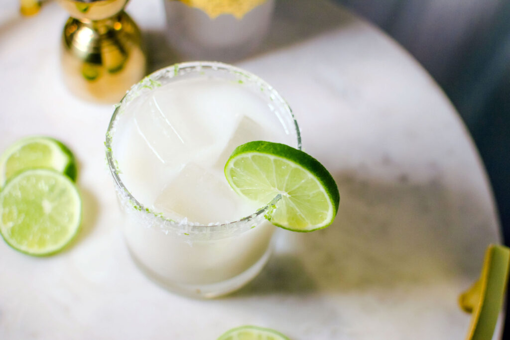 Quady Coco-Cream Margarita Recipe with Essensia Orange Muscat, coconut cream and Tequila in a rocks glass with a lime wheel garnish