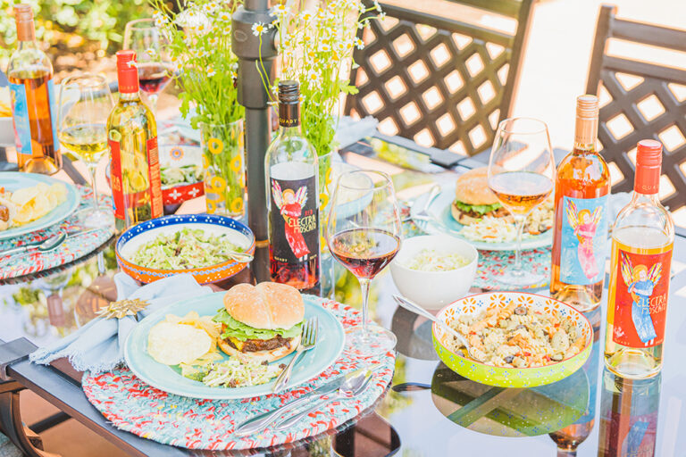 Party table with barbecue foods and Electra Moscatos