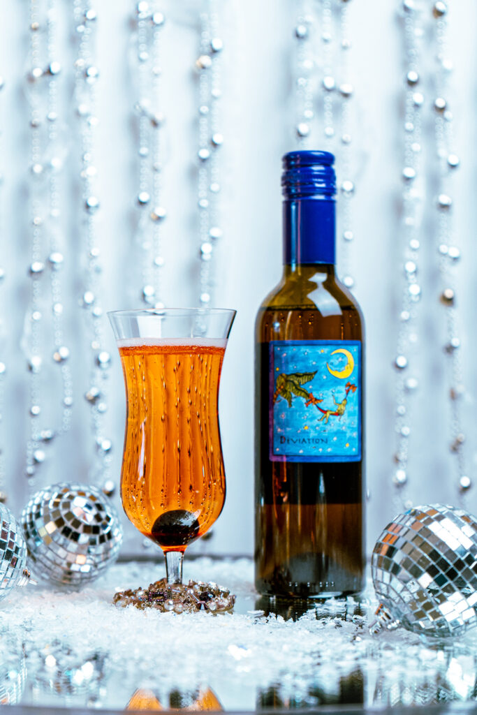 Deviation sparkling wine cocktail with a bottle of Deviation and sparkling ornaments