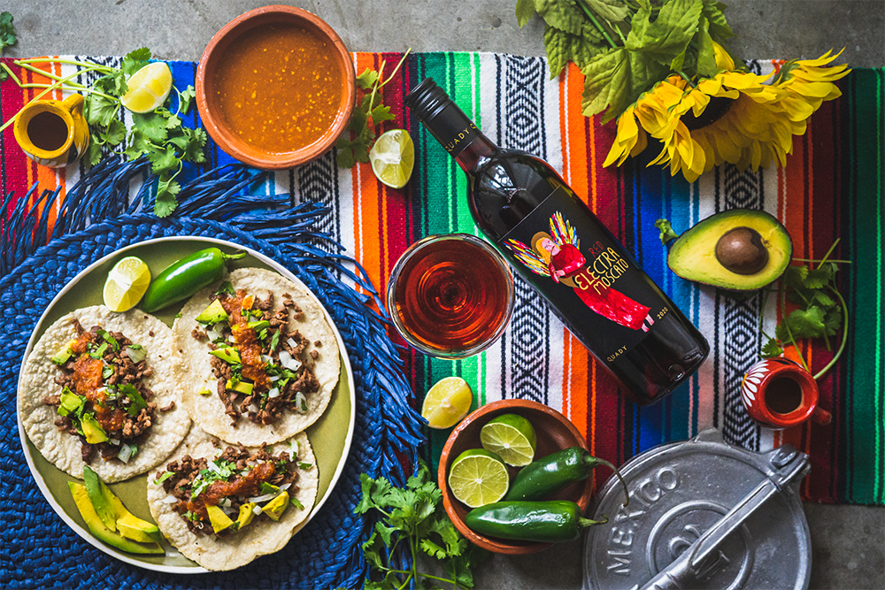 Red Electra Moscato with salsa and a plate of tacos